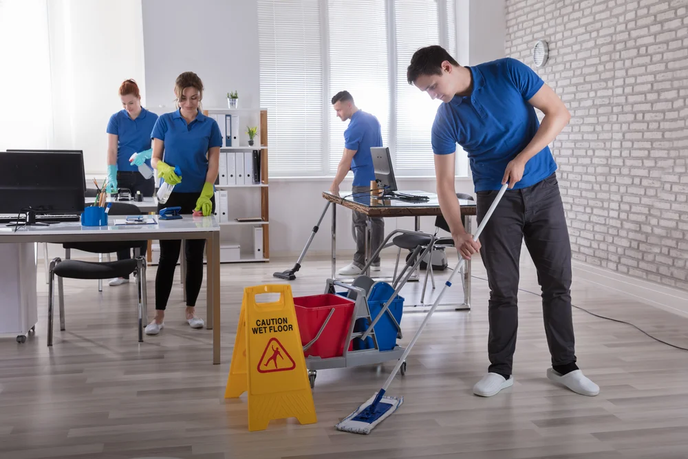 Office cleaning crew performing janitorial services in a commercial building
