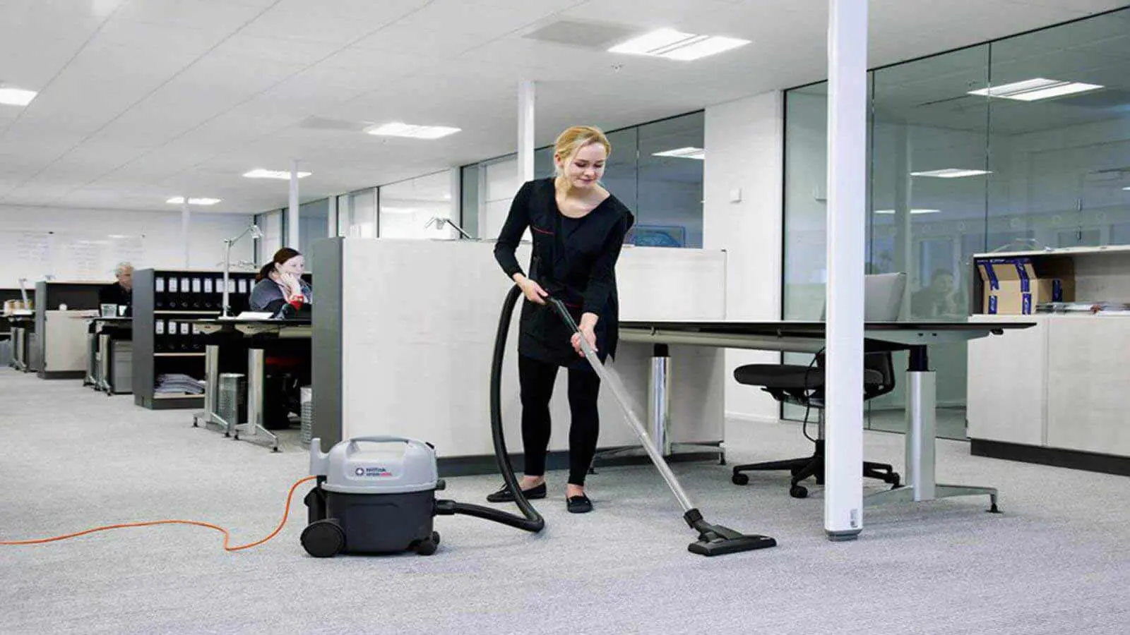 Office cleaning staff performing daily commercial cleaning, dusting, vacuuming, trash removal, restroom sanitation, and break room cleaning in Harrisburg PA.
